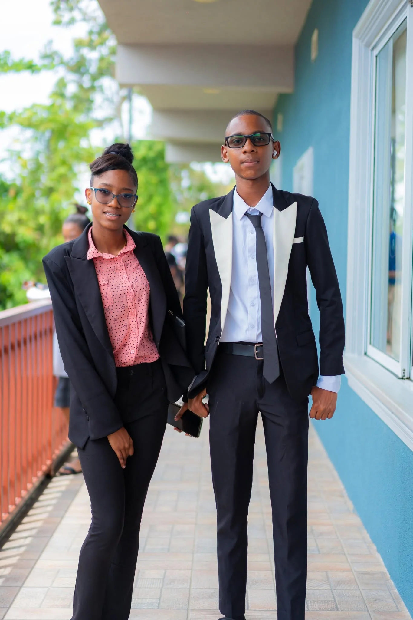 Two students in formal clothing in the school corridor